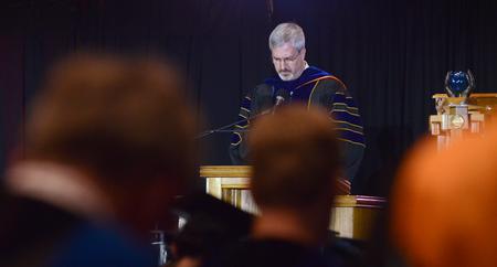 Joel S. Owen, professor Pharmaceutical Sciences, gives the invocation at Spring graduation.  - Photo by Elizabeth Wilson