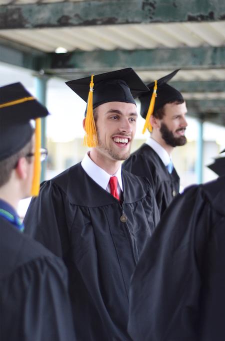 Joshua Guthrie, mechanical engineering graduate, converses with his fellow engineering graduates before the spring commencement services begin. - Photo by David Parks