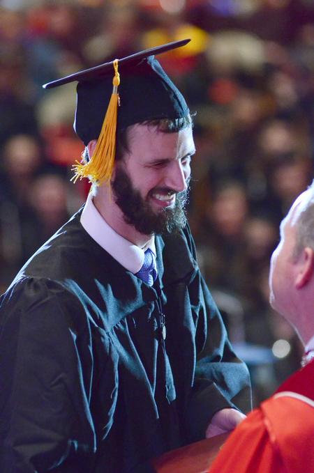 Shane Caver, electrical engineering graduate, greets Dub Oliver, president of the university, during the spring commencement services. - Photo by David Parks