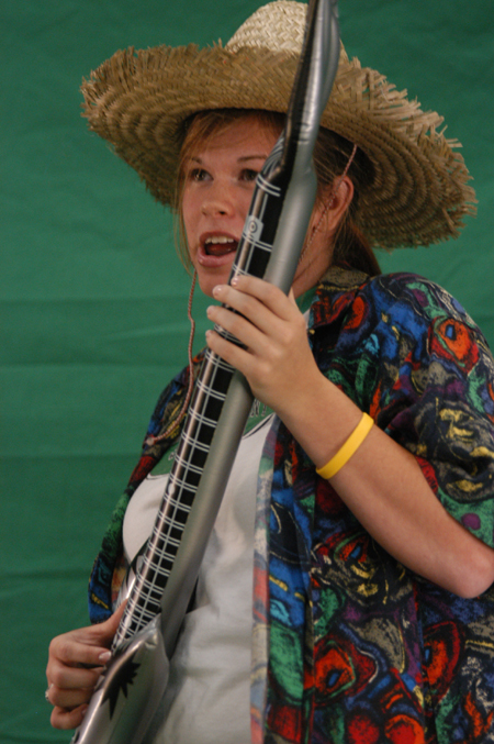 Senior Kate Mosley plays a mean inflatable guitar in a green screen music video during Fall Fest '04. - Photo by Jonathan Blair