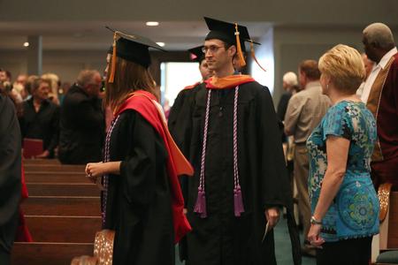 Nathan Birky, master of science in nursing graduate, walks with his fellow graduates to his seat during Summer Graduation. - Photo by Kristi McMurry Woody