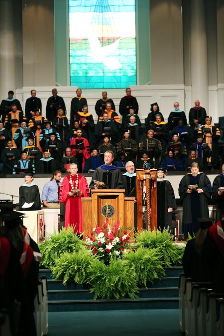 Chris Mathews, professor of music and department chair, leads the Summer Graduation audience in singing the Alma Mater.  - Photo by Kristi McMurry Woody