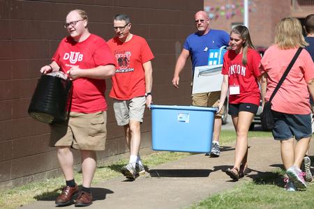 Keith Bates, professor of history, helps a new student during move-in day. - Photo by Kristi McMurry Woody