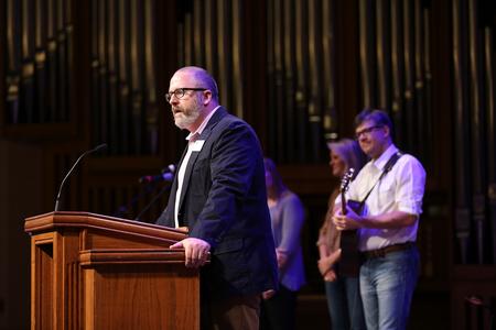 Nathan Finn, dean of the School of Theology and Missions, leads new students and their families in a responsive reading during Welcome Week chapel. - Photo by Kristi McMurry Woody