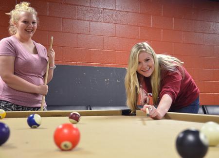 Melodie Fitzpatrick, junior social work major, concentrates on her game of pool during the Student Activities Council's Welcome Week Fest in the Bowld Commons.  - Photo by Sol Bee Park