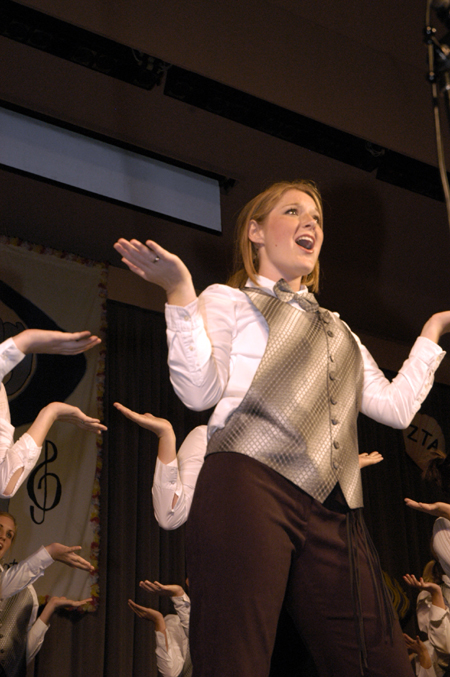 Freshman Carolyn Negley struck a pose with the rest of the Chi Omega team during All-Sing 2004. - Photo by Kathleen Murray