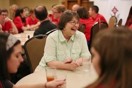 Mary Anne Poe, professor of social work, laughs with new students during Dinner with your Department. - Photo by Kristi McMurry Woody