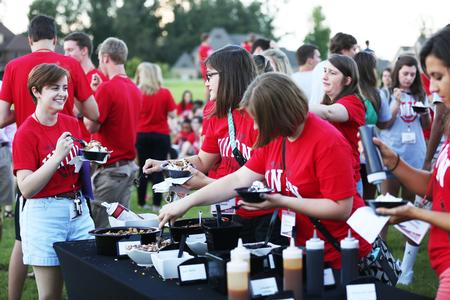 New students enjoy an ice cream party held at the president's home during Welcome Week. - Photo by Kristi McMurry Woody