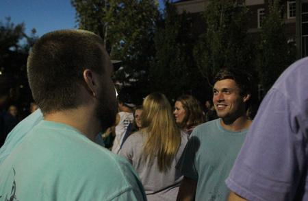 Ben Melton, junior biology major, enjoys a conversation with his friends during the Howdy Party hosted by the Student Government Association on the Great Lawn. - Photo by Sol Bee Park