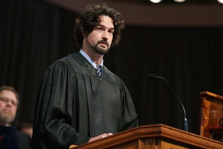 Scott Heit, assistant vice president for university communications and staff member of the year, reads scripture during Convocation. - Photo by Kristi McMurry Woody