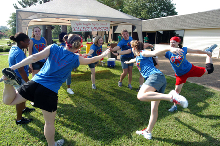Members of SAC stretch before helping freshmen move in during New Student Orientation. - Photo by Morris Abernathy