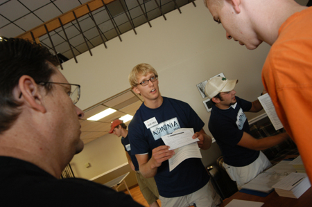 Residence assistants Nathan Michael and Chris Campbell help incoming freshmen with their dorm assignments during Freshmen Move-In. - Photo by Morris Abernathy