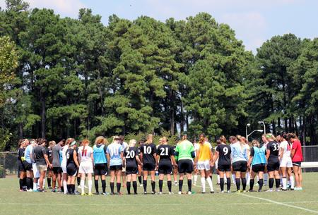 Union University and Mckendree University players finish the first game of the season in prayer.  - Photo by Sol Bee Park