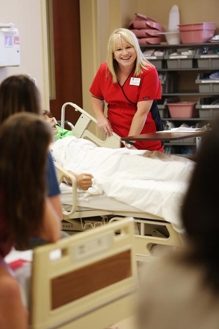 Jennifer Delk, assistant professor of nursing, introduces MSN students to the equipment they'll be using in the Skills Lab in Providence Hall.  - Photo by Kristi McMurry Woody