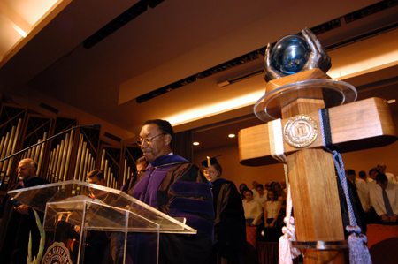 Roland Porter, new associate professor of business administration, prays during Fall Convocation 2004. - Photo by Morris Abernathy
