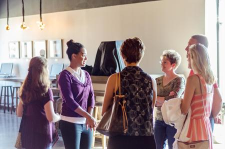 Student Ambassador Morgan Moody shows her tour group around the Barefoots Joe, the student coffee house, during Day at the U. - Photo by David Parks
