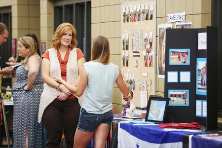 Julie Glosson, professor of language, speaks with a student about study abroad options at the External Study Fair. - Photo by Kristi McMurry Woody