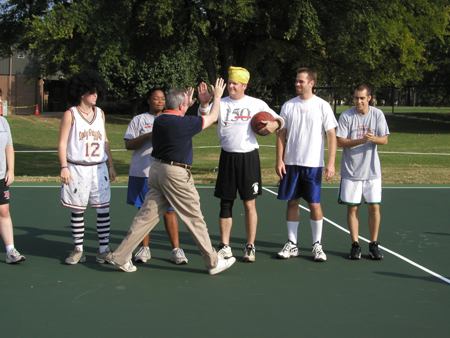 President David S. Dockery greets his teammates at the Faculty/Staff vs. Student basketball game at the dedication of the Class of 2002 Basketball Court.  Team members pictured include from left to right: Katie Woodruff, Tonya Tuggles, Dr. Paul Jackson, Bobby Ludwig, & Jay Ridenour. - Photo by Cam Tracy
