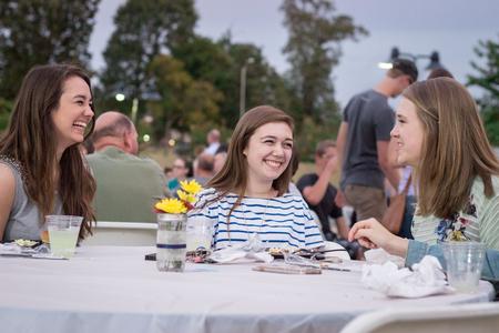 Zeta Tau Alpha sisters Anna Cook, freshman biology major, Rachel Lewis, sophomore biology major, and Laura Ritcheson, junior business administration major, laugh together at the Chi Omega Make-A-Wish Barbecue during Family Weekend. - Photo by David Parks
