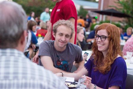 Seniors Zach Lancaster, art major, and Bethany Malchuk, music major, enjoy food and conversation at the Chi Omega Make-A-Wish Barbecue. - Photo by David Parks