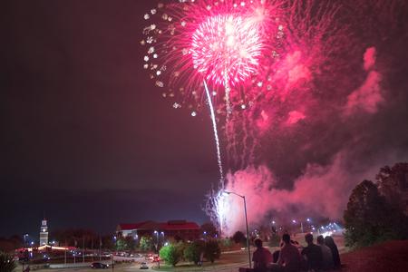 From a nearby hill, students overlook the fireworks show above campus during Union Night, concluding Union University's Family Weekend. - Photo by David Parks
