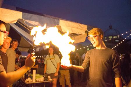 Joshua Mays, freshman conservation biology major,  gets his hand (safely) set on fire at a booth during Union Night. - Photo by David Parks