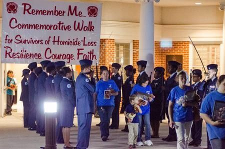 A color guard of junior ROTC cadets honors victims of homicide as their loved ones participate in the Remember Me Walk, a yearly event hosted by the Center for Just and Caring Communities. - Photo by David Parks