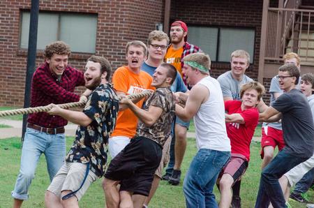 Men of Grey valiantly endure during the tug-of-war in the annual DF Olympics on the Heritage Complex lawn. - Photo by David Parks