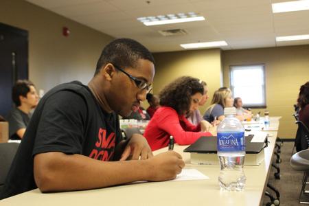 Students take notes during a lecture on graduate school preparation provided by the Hundley Center. - Photo by Sol Bee Park
