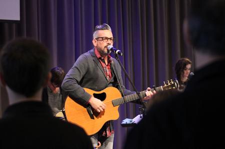 The congregation follows the worship leader in praise during chapel. - Photo by Sol Bee Park
