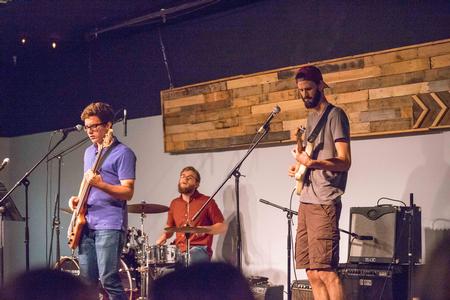 Tanner Cherry, sophomore computer science major, David Key, and Shane Caver, electrical engineering alumnus, conclude Open Mic Night in Barefoots Joe with an entertaining piece. - Photo by David Parks