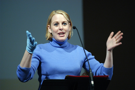 Dean of students Kimberly Thornbury wore a blue rubber glove throughout the Day of Remembrance as a symbol of getting our hands dirty to help others. - Photo by Morris Abernathy