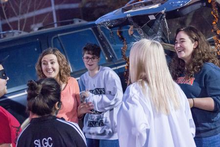 Members of the University Feminist Organization chat and laugh during Trunk or Treat, an event by the Student Government Association. - Photo by David Parks