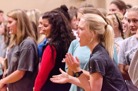 Morgan Ballek, junior nursing major, cheers for her Chi Omega sister during the wall-sitting challenge in the Union's Fittest Team competition. - Photo by David Parks