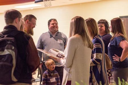 Alumnus Brandon Nelms, alongside his son, catches up with former classmates during the Class of 2005 Reunion. - Photo by David Parks