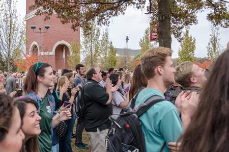 Members of the student body rejoice upon the opening of the Logos Library during its dedication ceremony. - Photo by David Parks