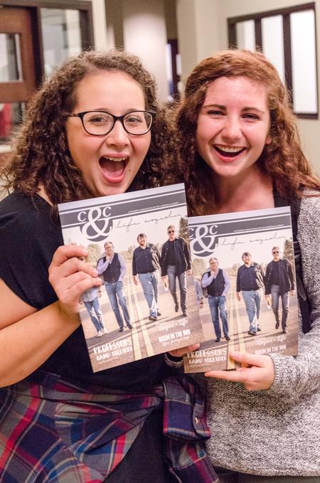Vanessa Rivera, junior nursing major, and Michayla Kramer, sophomore mathematics and political science major, pose for a photo as they brandish copies of the newly-released edition of Cardinal & Cream Magazine. - Photo by David Parks