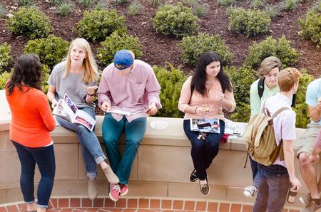 Students relax on the patio of the Logos, at the end of its opening dedication ceremony. - Photo by David Parks