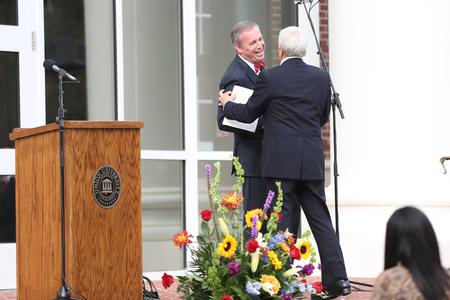 Dub Oliver, president of the university, welcomes Bill Latimer to the podium during the dedication of The Logos. - Photo by Kristi McMurry Woody