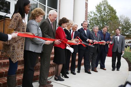 The ribbon to officially open the doors of The Logos is cut during the dedication service.  - Photo by Kristi McMurry Woody