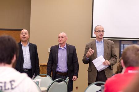 George Guthrie, Benjamin W. Perry Professor of Bible Senior Fellow (right), introduces guest speakers in the Coburn Dining Hall. - Photo by David Parks