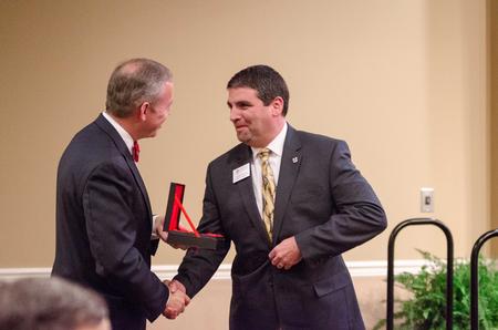E. Blake Watkins, recipient of the G.M. Savage Legacy Award, receives a word of congratulations from Dub Oliver, president of the university during the Meritorious Service Awards Banquet. - Photo by David Parks