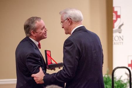 Dub Oliver, president of the university, is thanked by Mark H. Luttrell, recipient of the Distinguished Achievement Award in Government/public Service during the Meritorious Service Awards Banquet in the Carl Grant Events Center. - Photo by David Parks