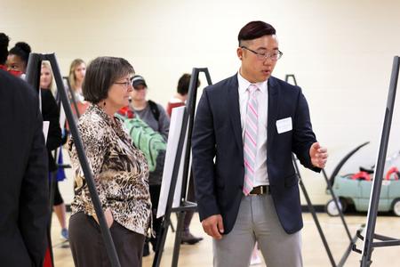 Jonathan Suh, senior social work major, presents his study to Mary Anne Poe, professor of social work, at the Fall Poster Session. - Photo by Sol Bee Park