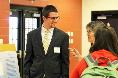 Chris Layne, senior social work major, talks about his research topic with Mary Anne Poe, professor of social work, at the Fall Poster Session. - Photo by Sol Bee Park