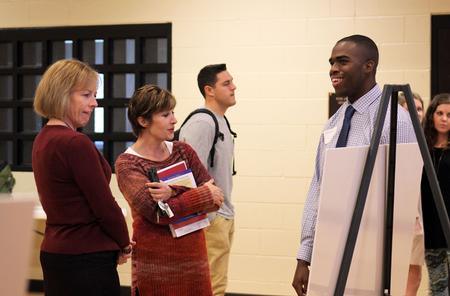Tre Tharp, junior social work major, presents his research topic to faculty during the Fall Poster Session held in the Bowld Commons.
