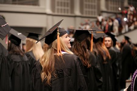 Students look around to spot friends and family at the beginning of fall commencement services.  - Photo by Kristi McMurry Woody