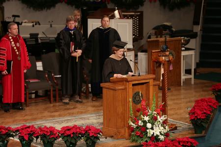 Luanne Powell, MBA program director, reads scripture during fall commencement services at West Jackson Baptist Church. - Photo by Kristi McMurry Woody