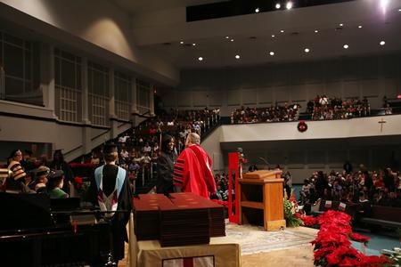 Dub Oliver, president of the university, shakes hands with graduates as they receive their diplomas during fall commencement services.  - Photo by Kristi McMurry Woody