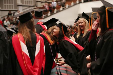 Graduates embraces prior to the second fall commencement service at West Jackson Baptist Church. - Photo by Kristi McMurry Woody